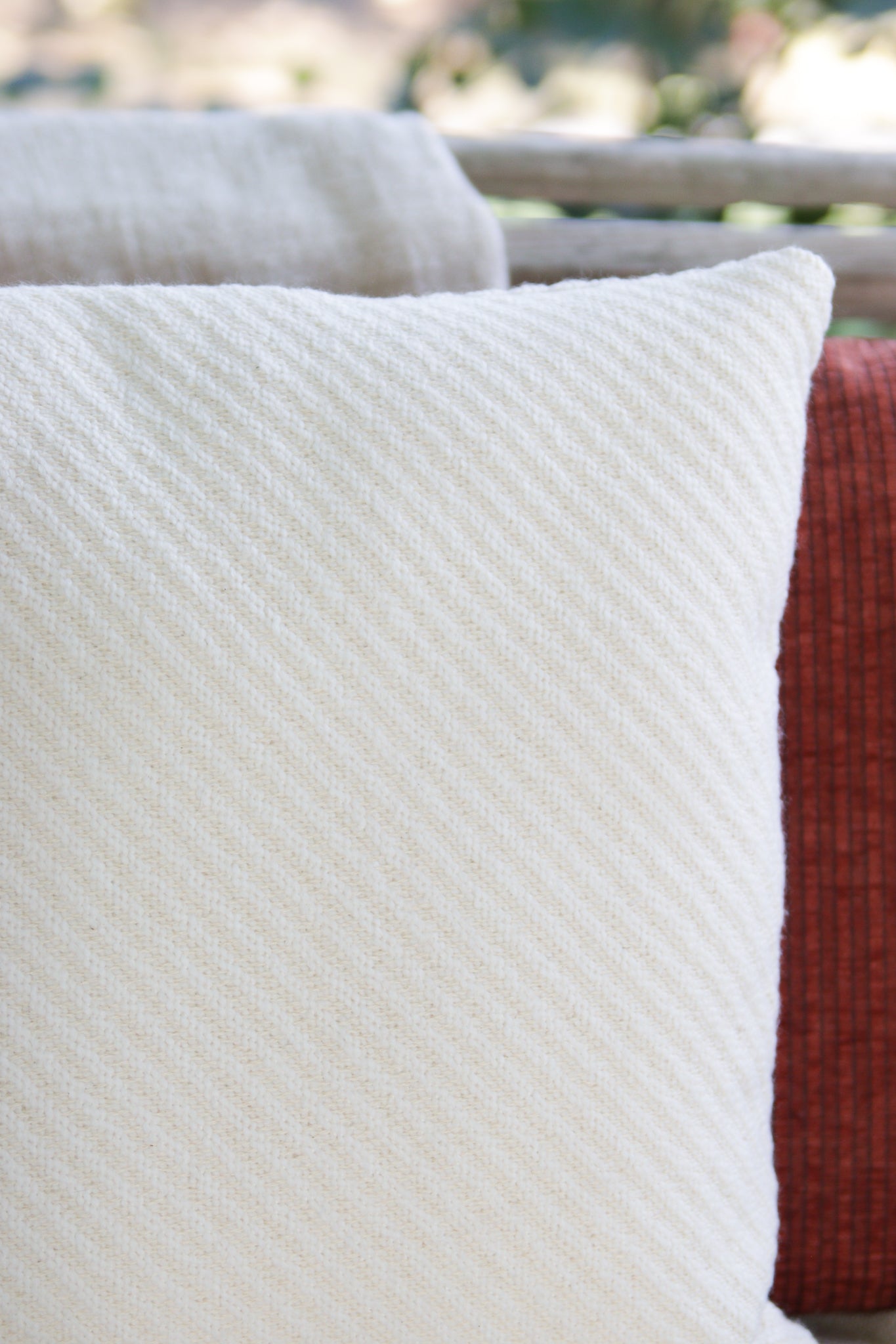 Close up picture of the cream and white texture fabric. The texture produces a diagonal raised line in the pillow cover fabric.